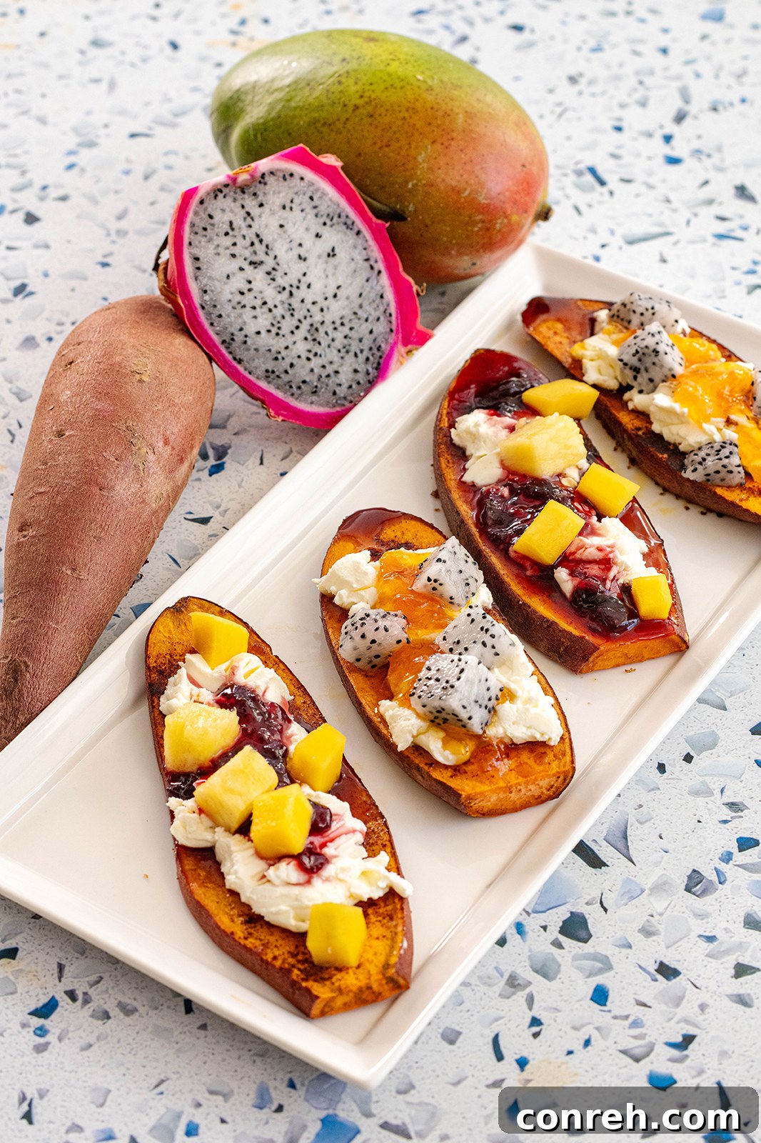 Overhead shot of two slices of sweet potato toast, one with cream cheese and the other with additional toppings