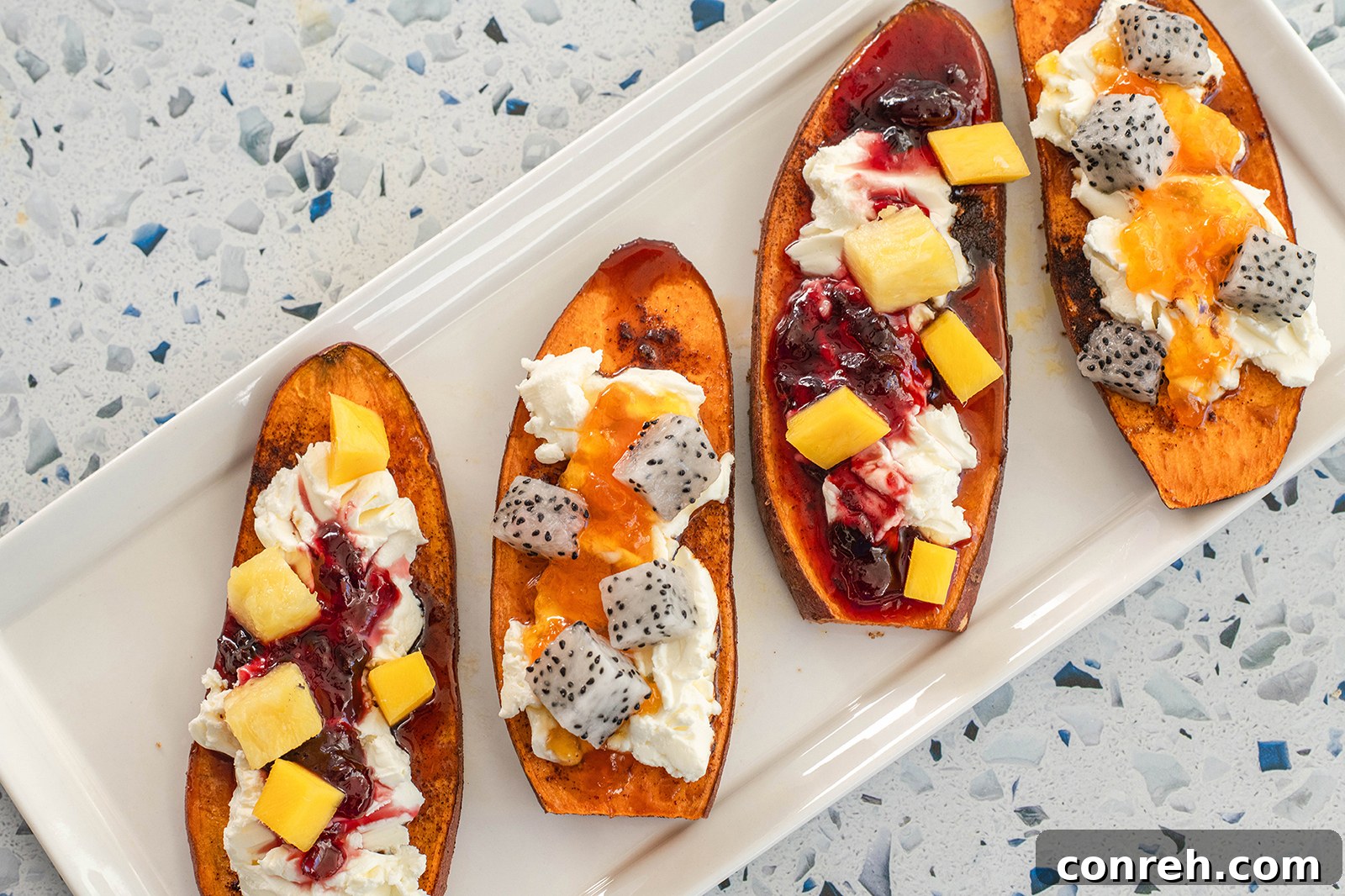 A beautifully arranged sweet potato cinnamon sugar toast with fresh berries and a drizzle of syrup