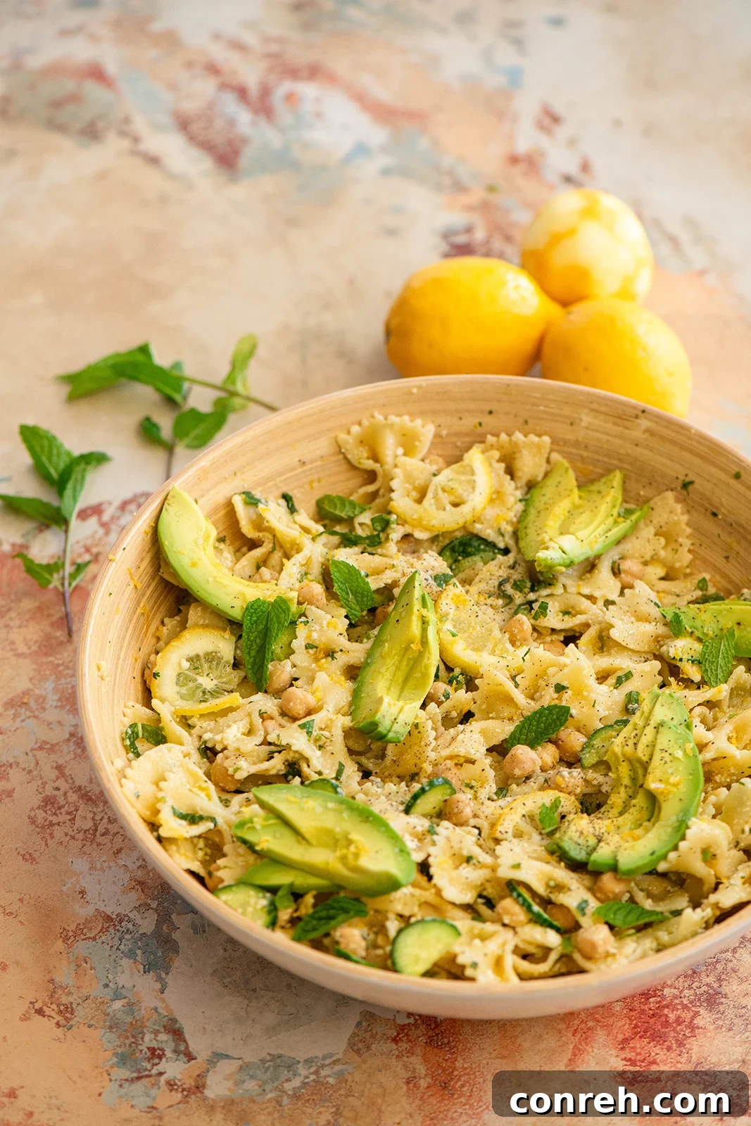 Vibrant Minty Lemon Pasta with Chickpeas, Cucumber, and Avocado ready for a summer picnic