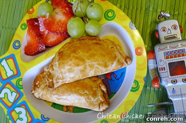 Delicious golden-brown Chilean Chicken Empanadas, perfect for a family meal or school lunch, freshly baked and ready to be enjoyed.