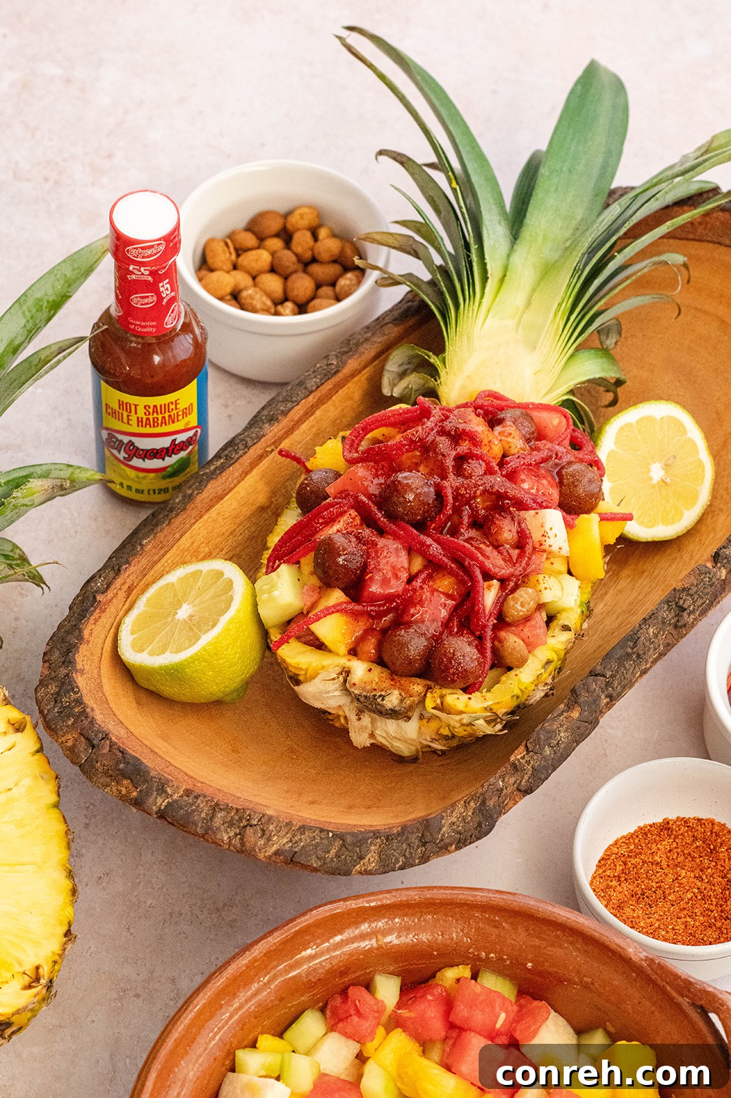 Wild Pineapple 4 Another perspective of Piña Loca, highlighting the scooped out pineapple vessel and colorful contents.