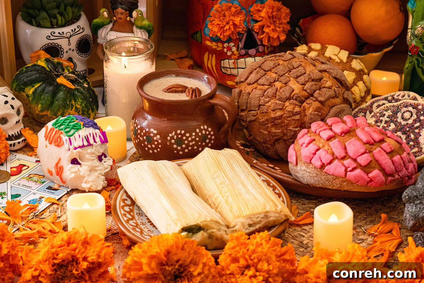 Close-up of a Día de Muertos altar with a framed photo, marigolds, candles, and traditional Mexican sweets, symbolizing remembrance and offerings.