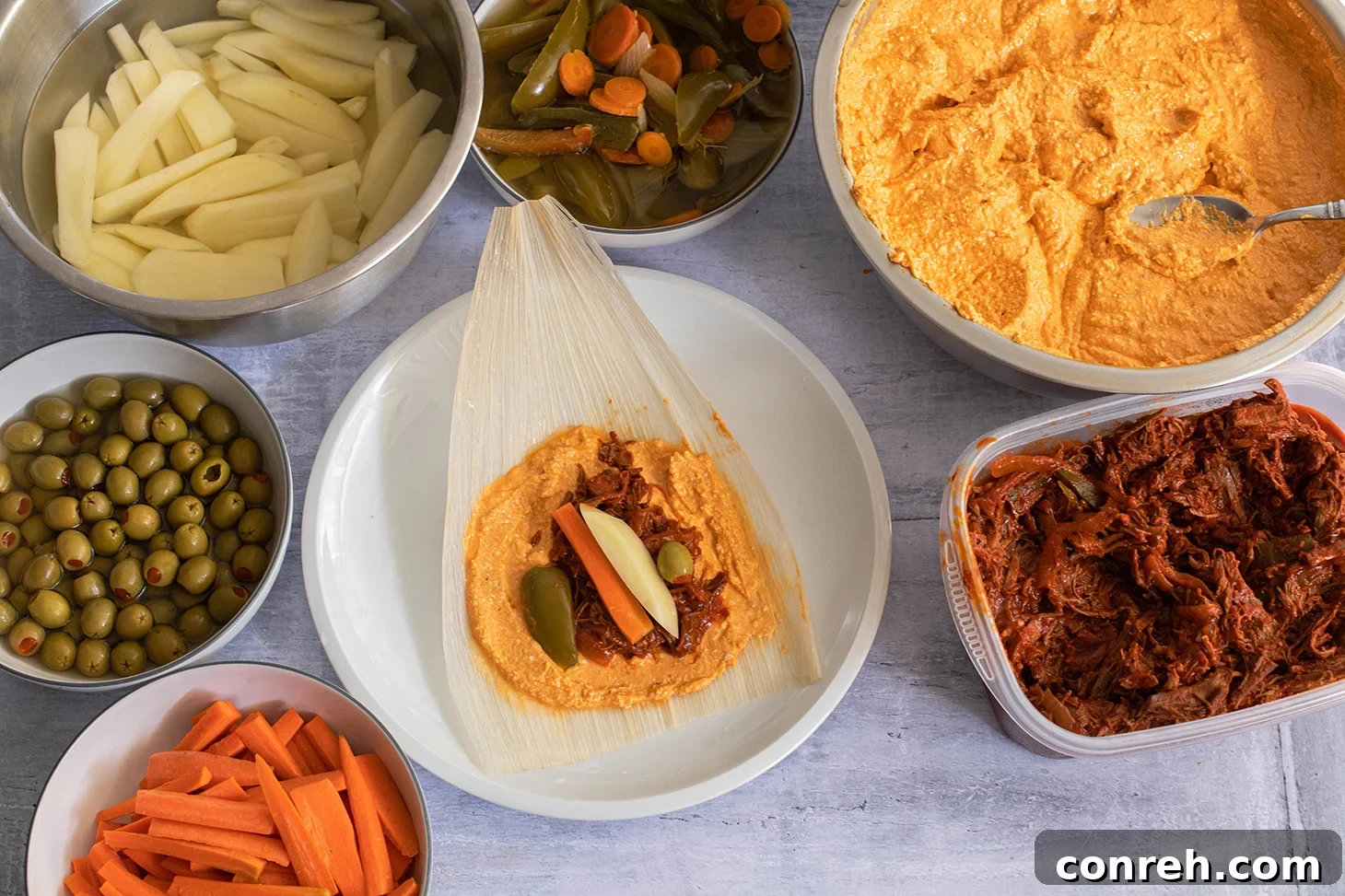 Platter of red chile beef tamales with traditional garnishes