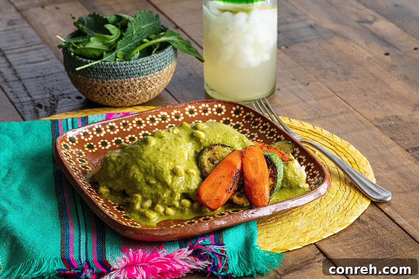 Close-up of Chicken Atakapua Verde with sauce and fresh ingredients