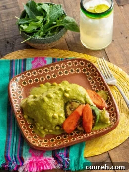A serving of Chicken Atakapua Verde, showcasing the vibrant green sauce and tender chicken.
