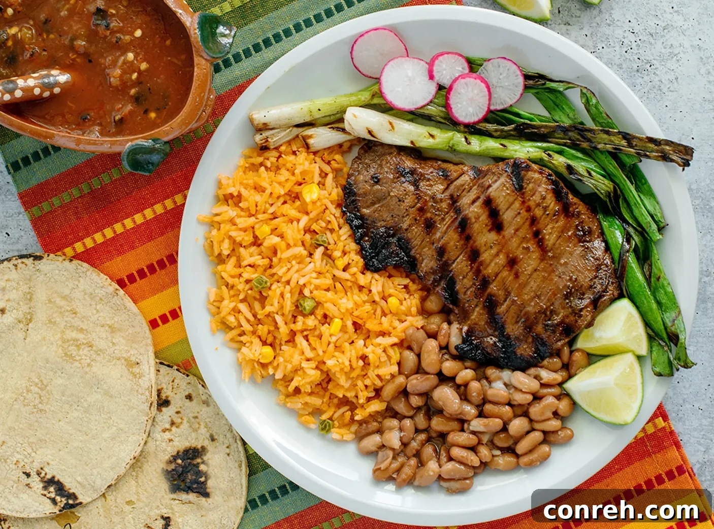 Assorted ingredients for Carne Asada marinade including citrus, onion, and beer
