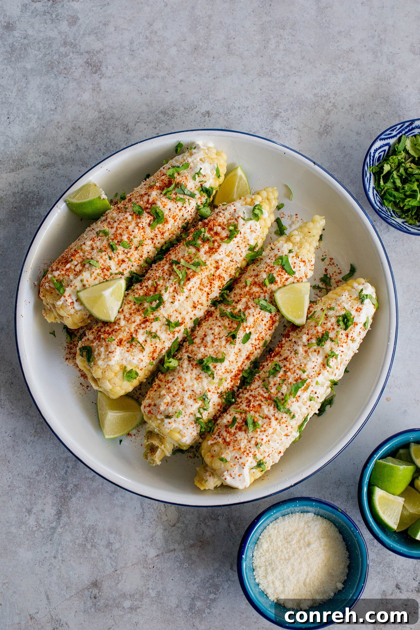 Freshly prepared elotes, Mexican street corn, with cotija cheese and chili powder.
