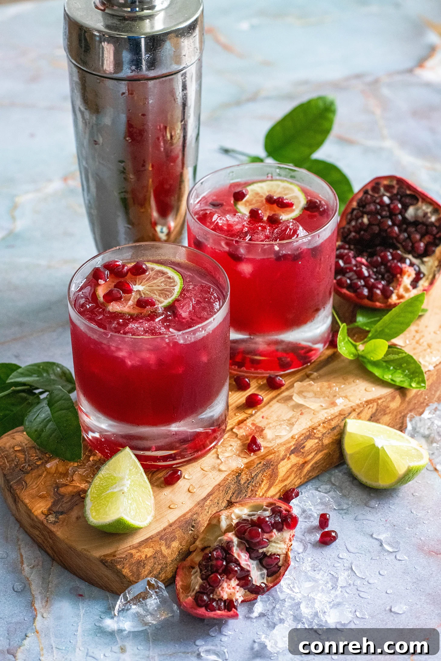 Vibrant Pomegranate Margarita garnished with lime and pomegranate arils.