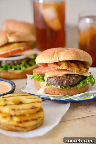 Tropical Burger, layered with grilled pineapple and a savory aioli, perfect for a unique BBQ.