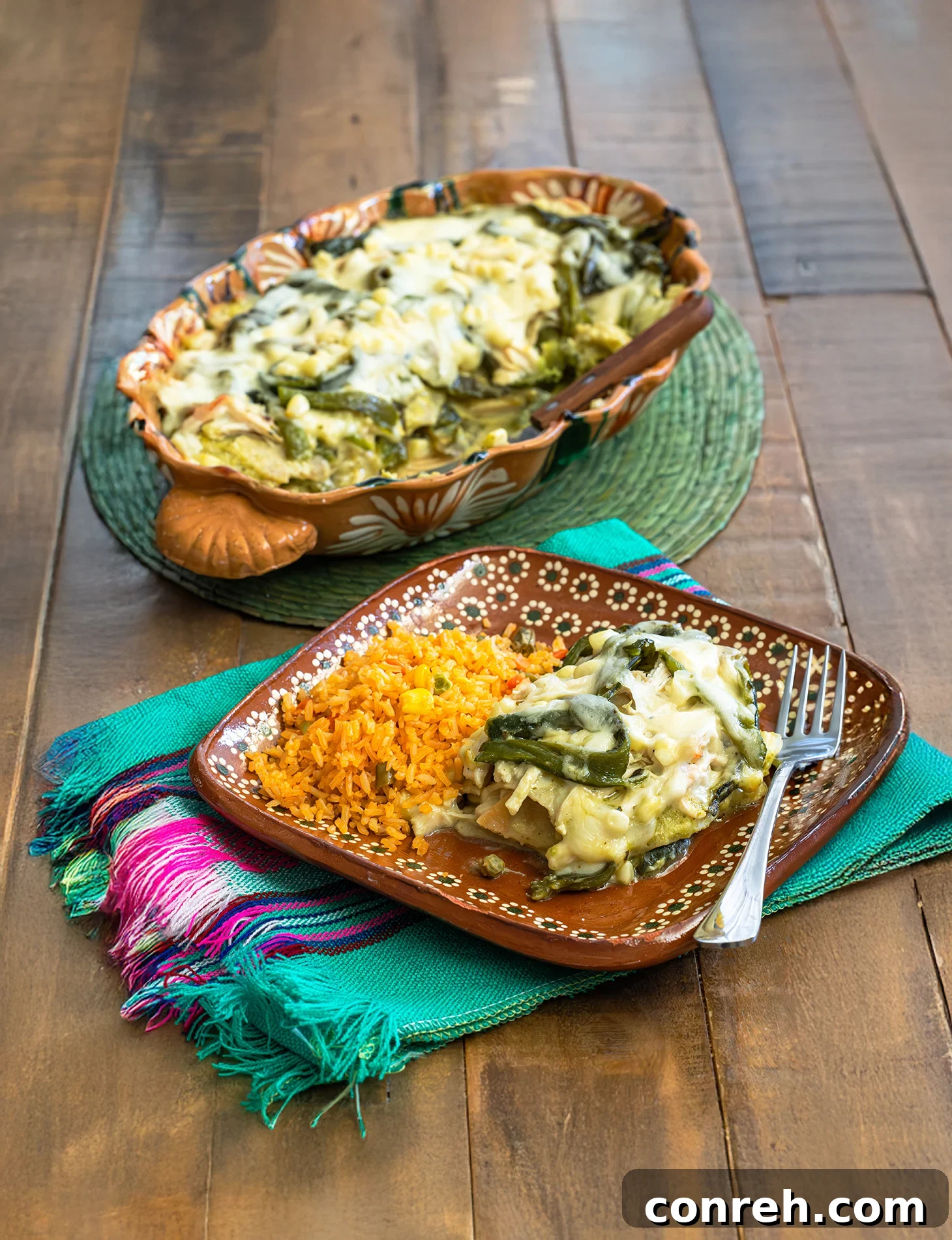 A beautifully layered Pastel Azteca casserole, golden brown and bubbling with melted cheese, ready to be served.