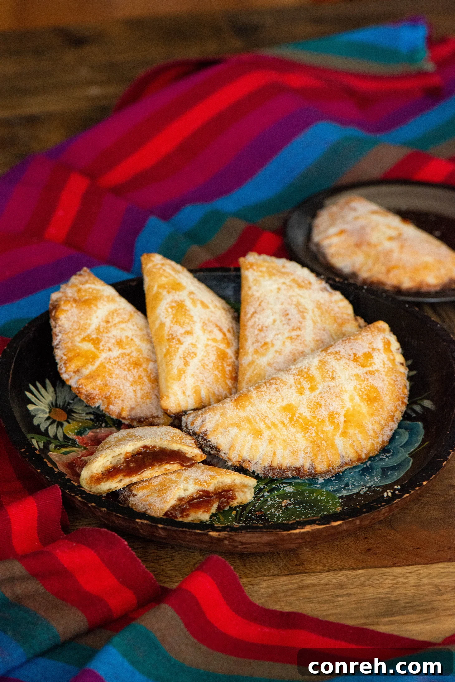 Decadent Dulce de Leche Pastries 2 Freshly baked Dulce de Leche Empanadas cooling on a wire rack.