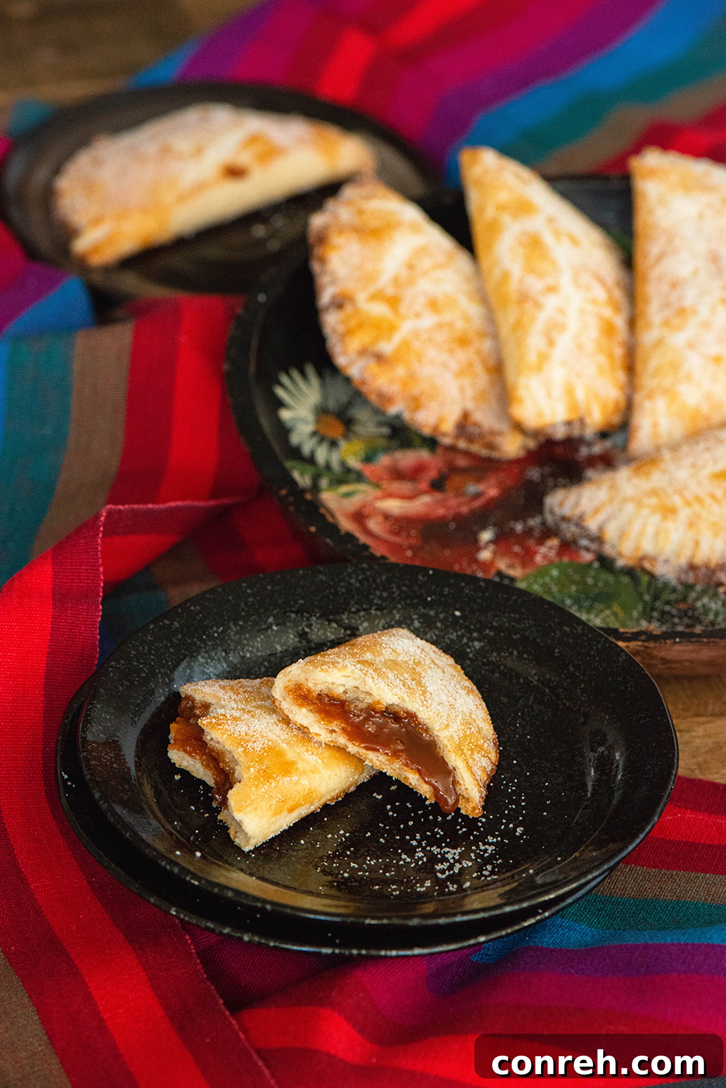 Decadent Dulce de Leche Pastries 4 Ingredients for making Dulce de Leche Empanadas laid out on a wooden surface.