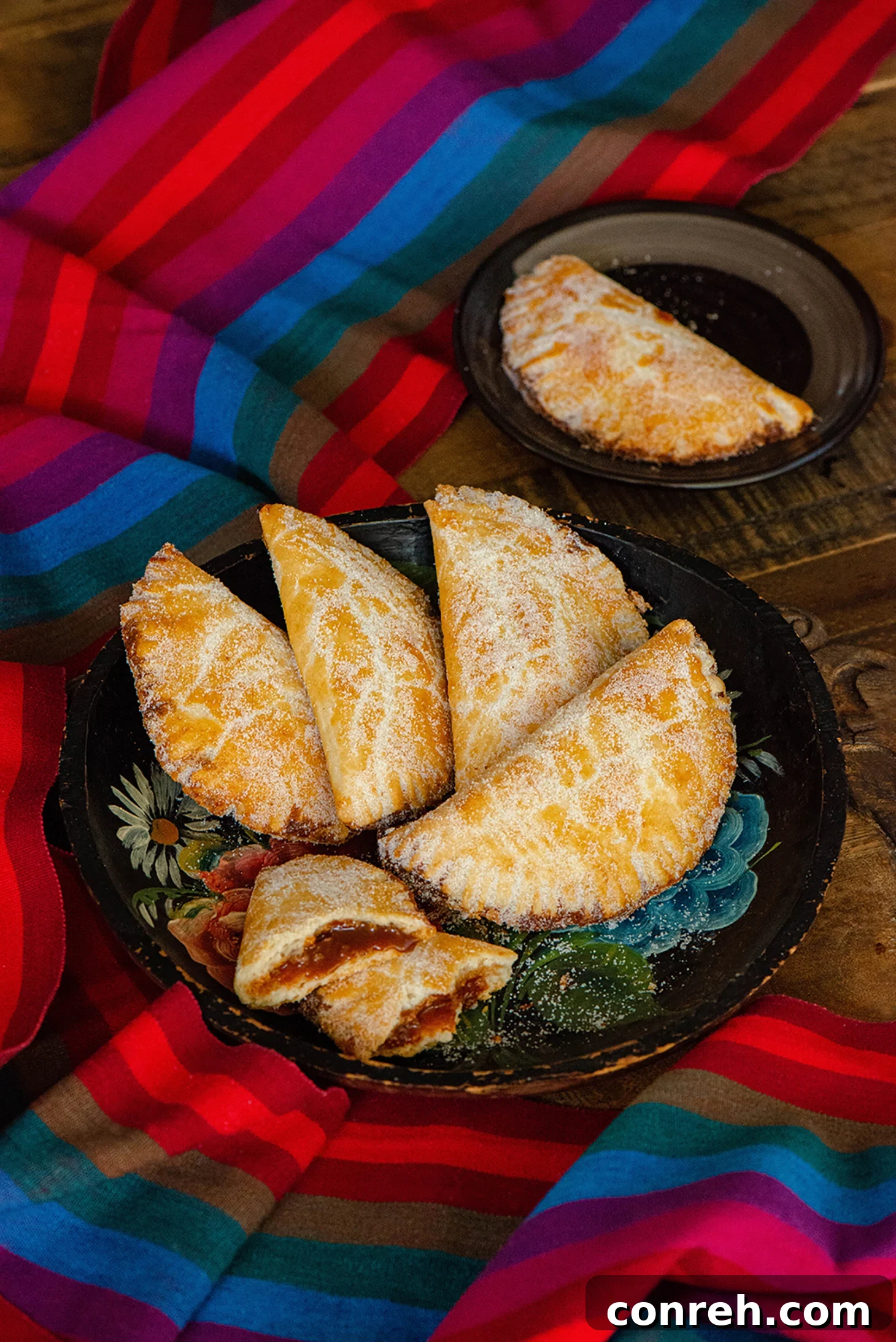 Decadent Dulce de Leche Pastries 5 A stack of golden Dulce de Leche Empanadas on a plate, ready to be served.