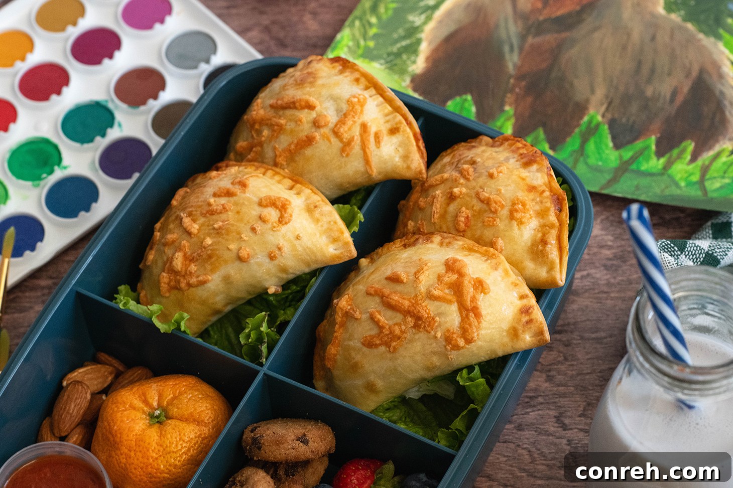 Close-up of a stack of Two-Cheese Pizza Empanadas with melted cheese peeking out.