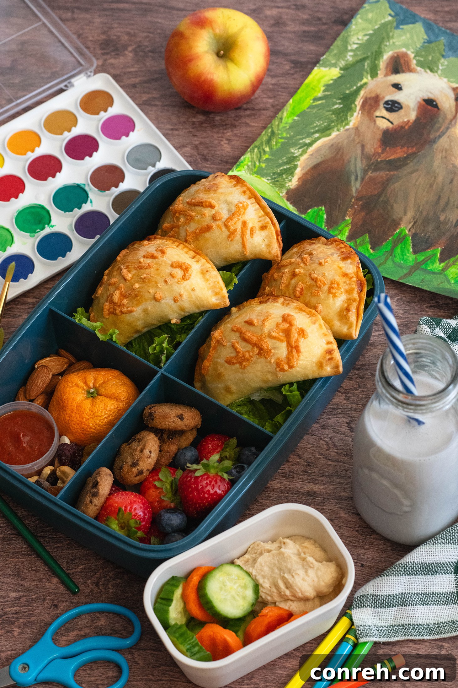 Two-Cheese Pizza Empanadas cooking in the oven, browning beautifully.