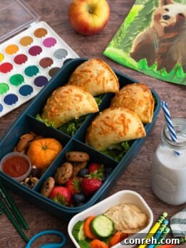 Two-Cheese Pizza Empanadas on a plate with dipping sauce