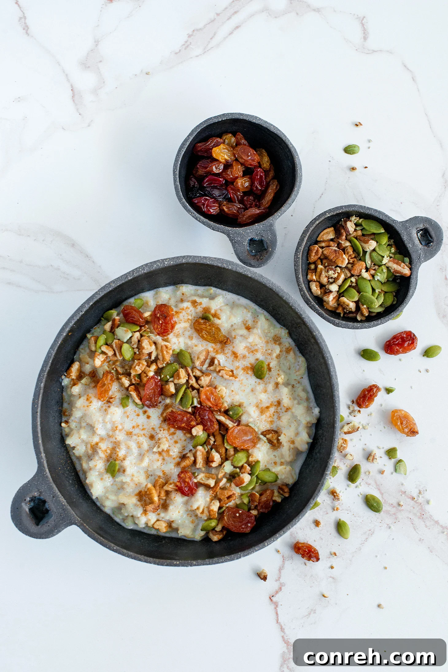 Fiesta Oatmeal 2 A comforting bowl of Mexican Oatmeal (Avena Mexicana) topped with nuts and raisins, reminiscent of cozy childhood mornings.