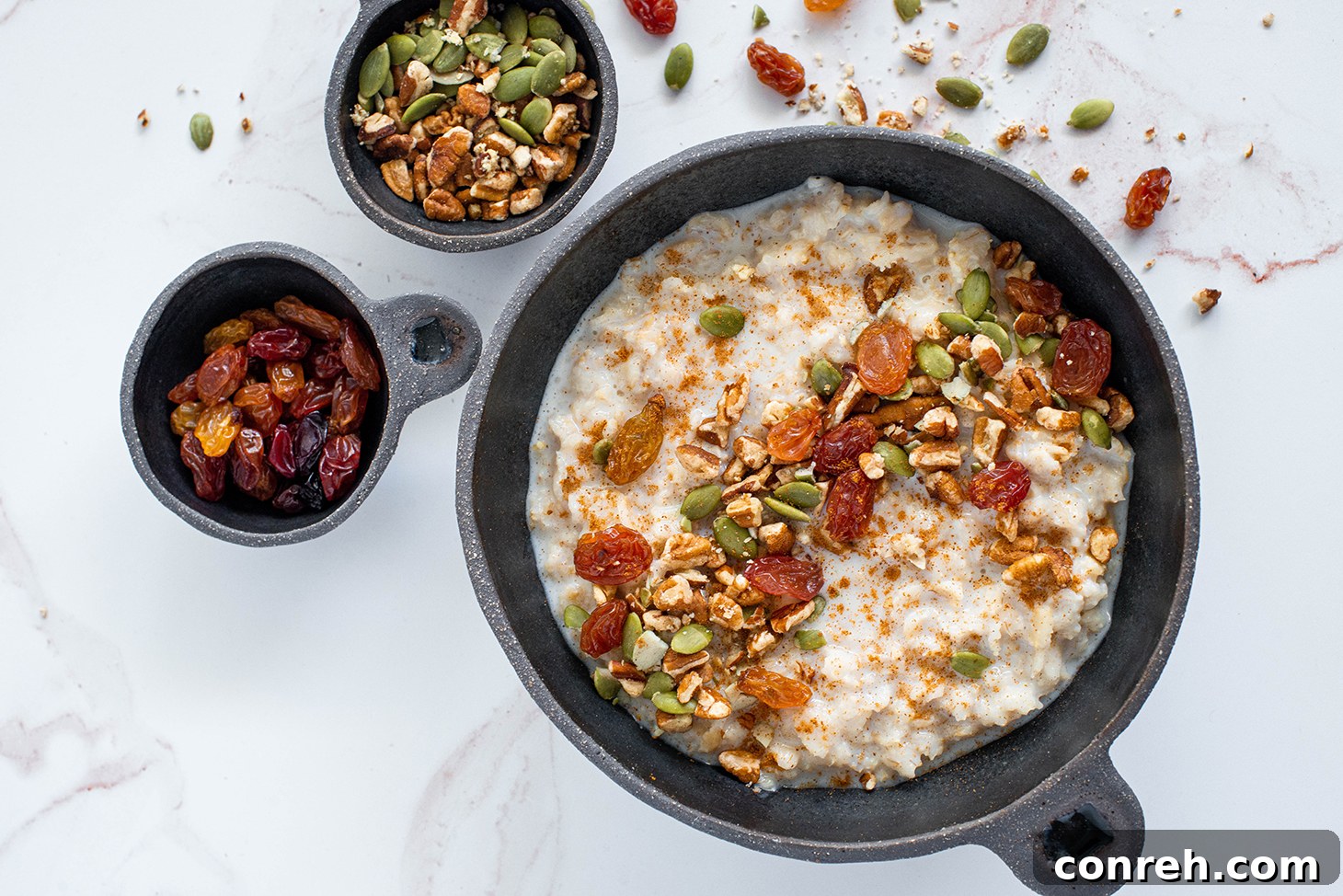 Fiesta Oatmeal 3 A close-up of creamy Mexican oatmeal with cinnamon sticks and orange peel, ready to be cooked.