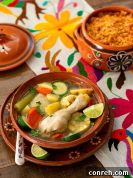 Caldo de Pollo with a chicken leg, corn, carrots, and potatoes