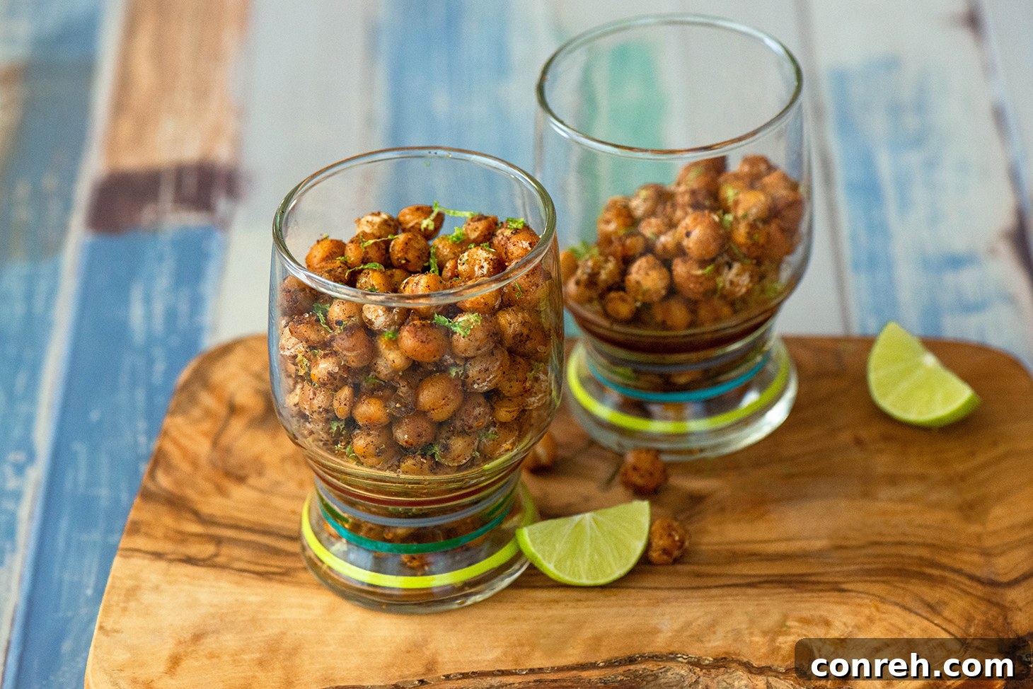 A close-up of Spicy Garbanzo Beans in a bowl, showing their crispy texture and vibrant seasoning.