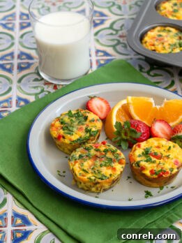 Four golden-brown Breakfast Hashbrown Nests in a muffin tin, garnished with fresh parsley.