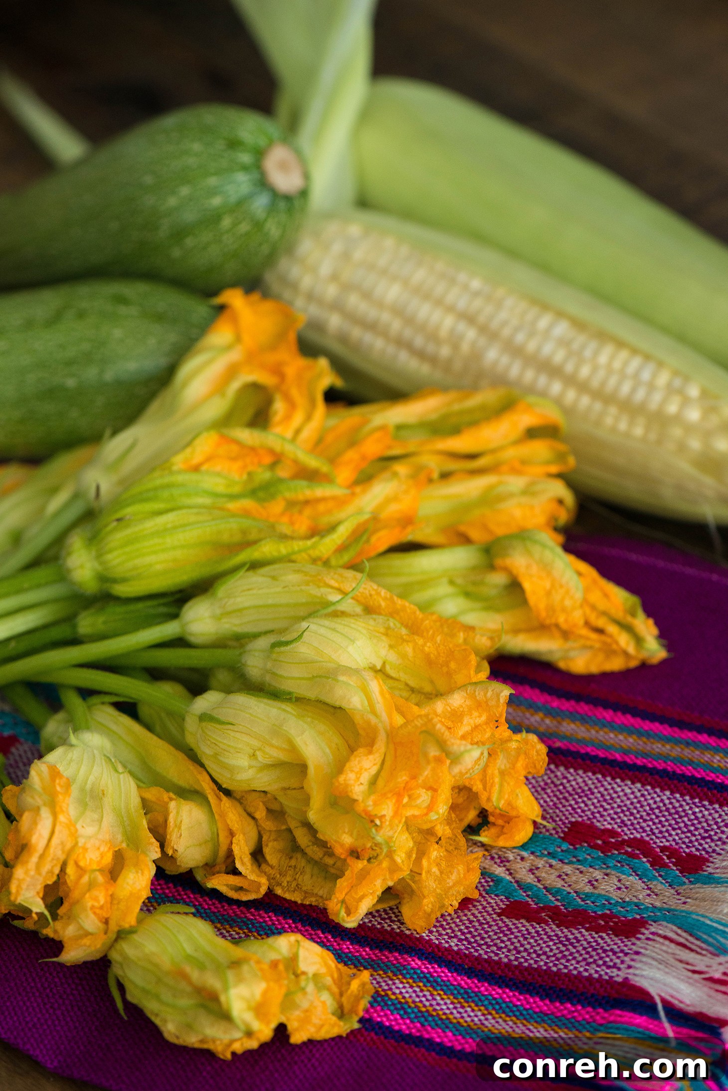 Close-up of fresh Mexican squash, corn kernels, and poblano peppers, ready for Sopa de Milpa preparation.