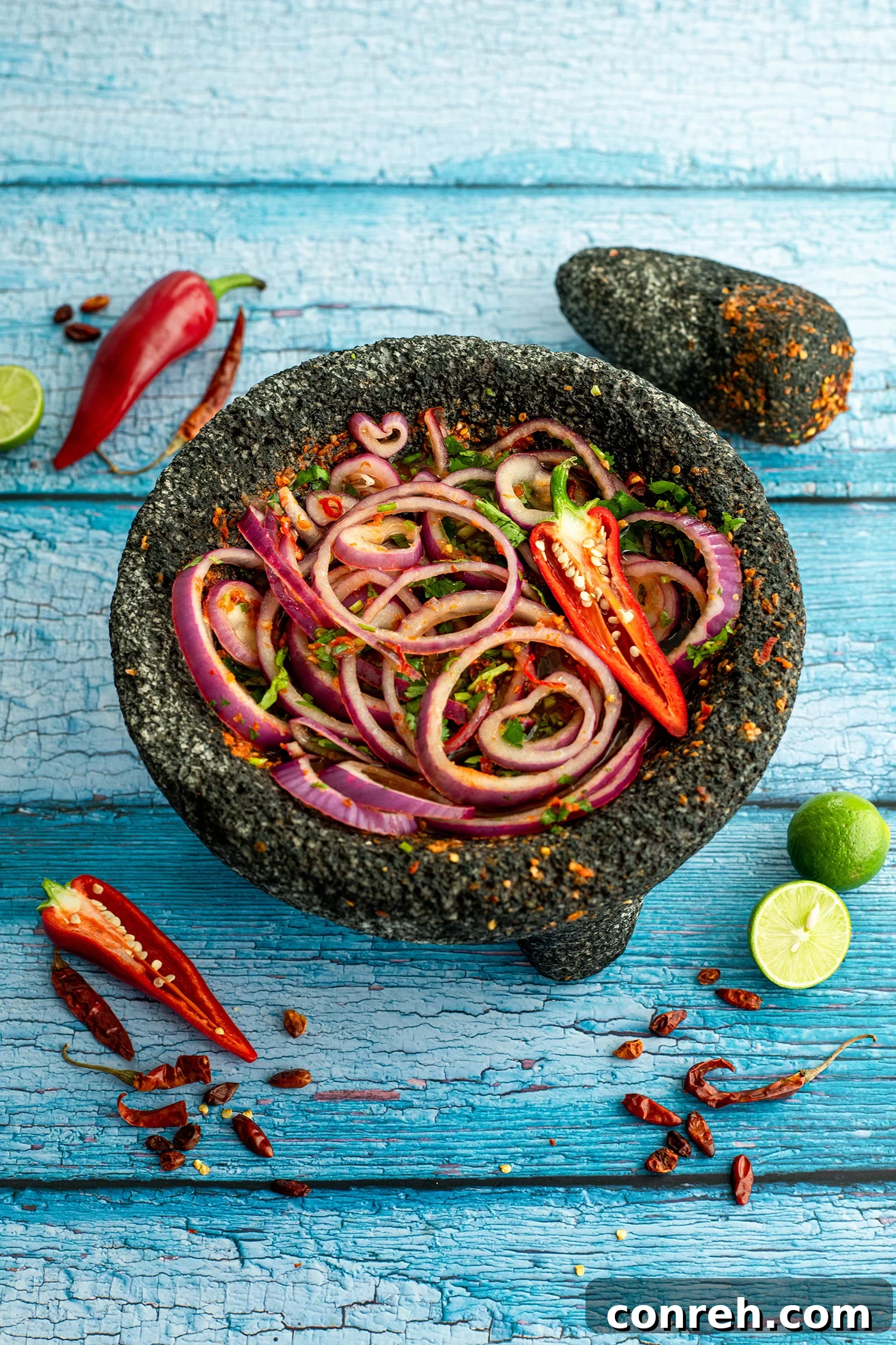 Chile Piquín Pickled Red Onions 3 Close-up of freshly sliced red onions being mixed with chile piquín, lime, and cilantro