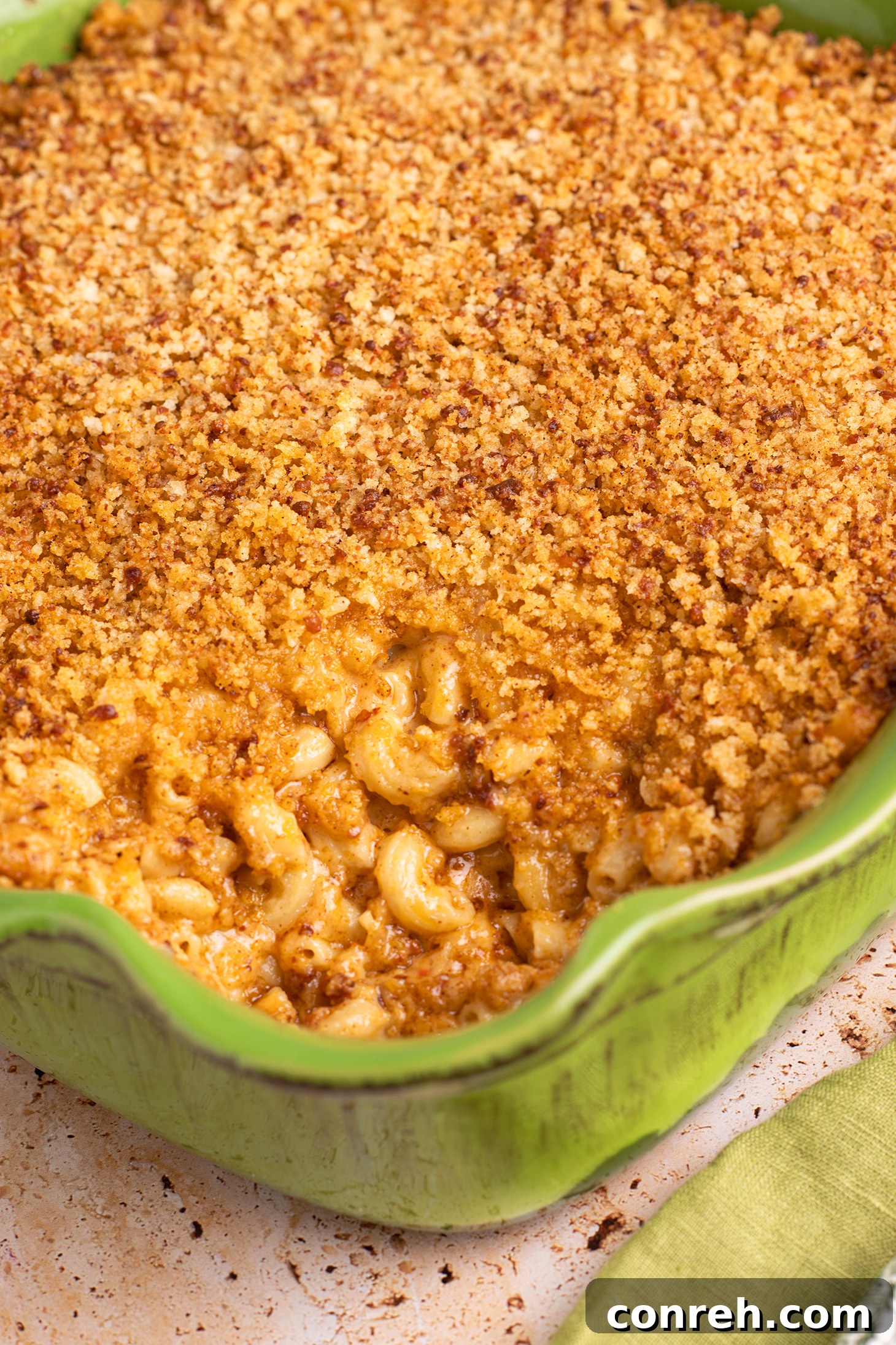 A large baking dish of Mexican Mac and Cheese with Chorizo, topped with golden crispy panko and Cotija.