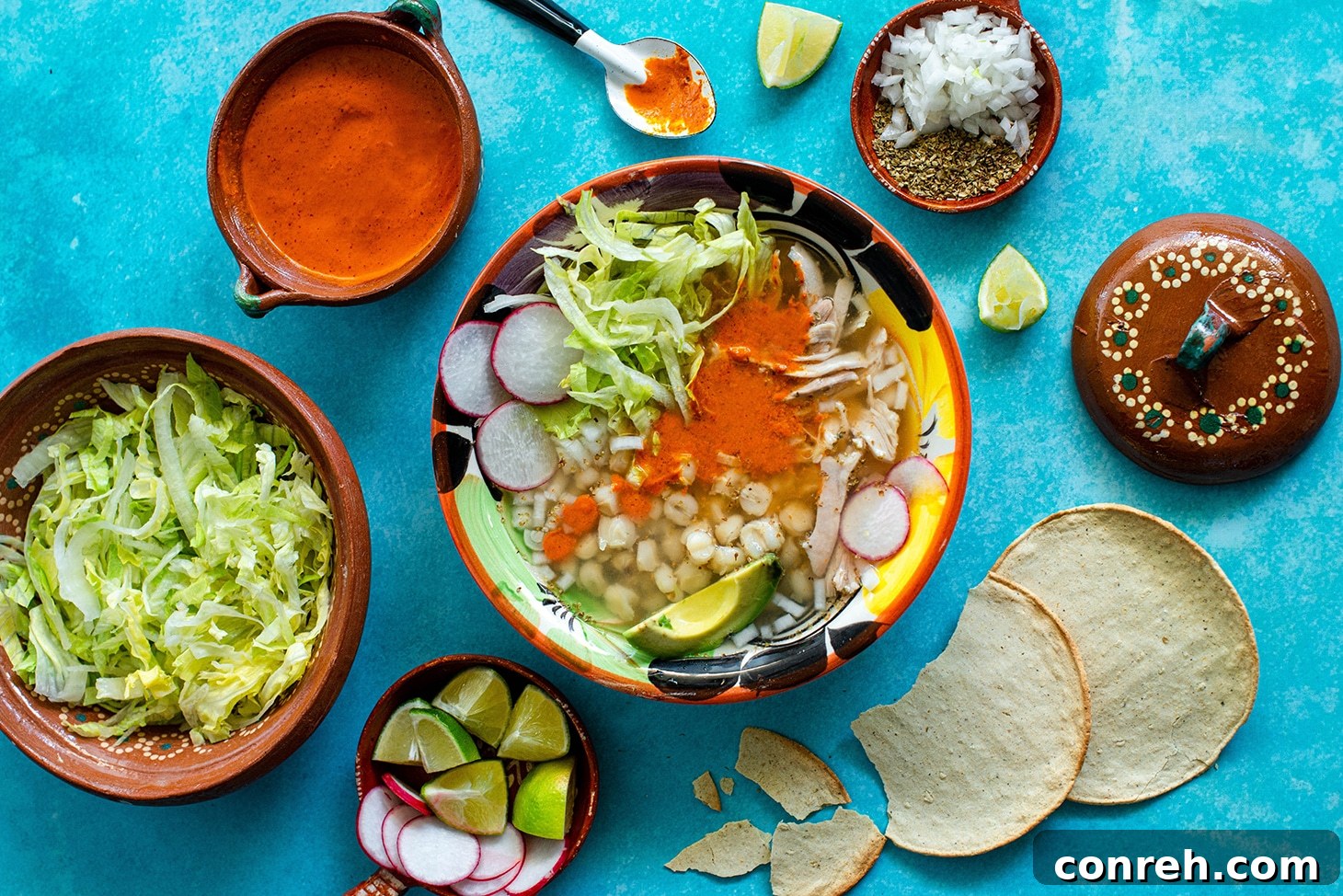 Hearty White Chicken Pozole 3 Close-up of a steaming pot of Chicken Pozole Blanco, showcasing the tender chicken and hominy in a clear broth.