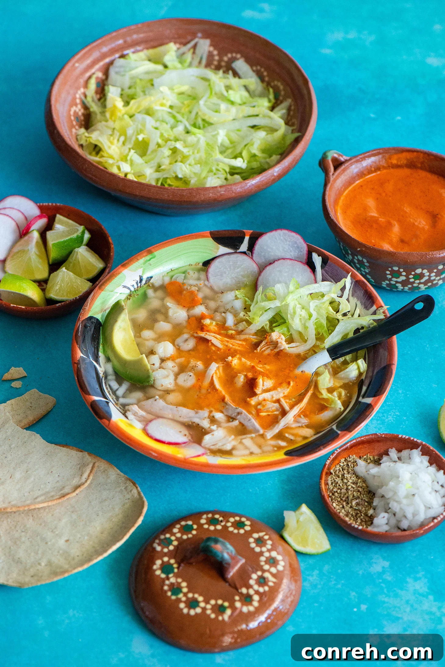Hearty White Chicken Pozole 4 A beautifully presented bowl of Chicken Pozole Blanco with various toppings, ready to be enjoyed.