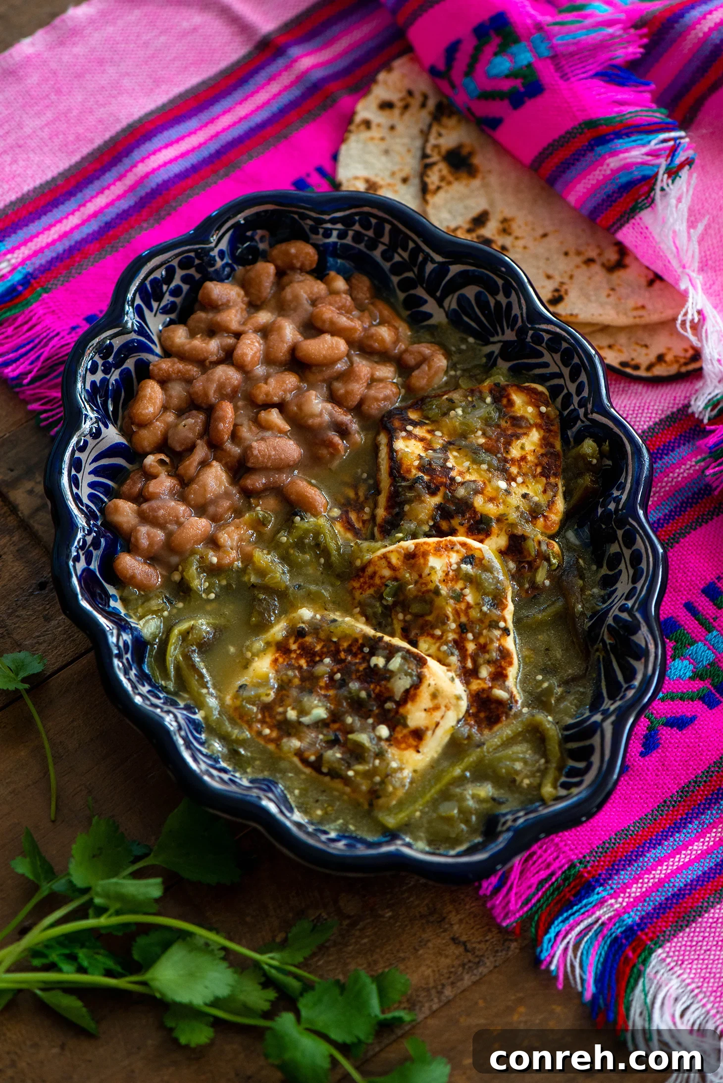 Close-up of Queso en Salsa Verde with cilantro garnish
