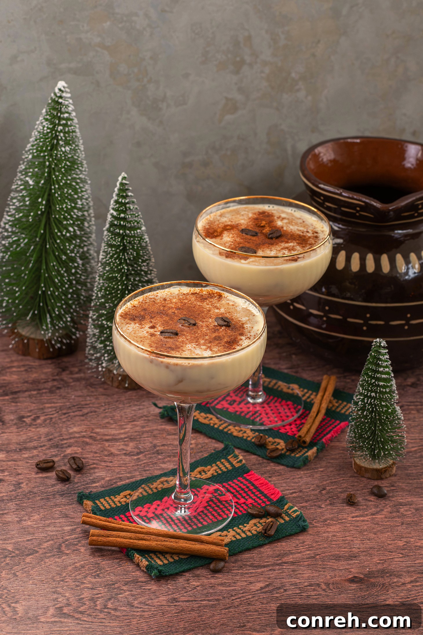 Close-up of Cafe de Olla Eggnog with creamy texture, garnished with a cinnamon stick and orange peel.