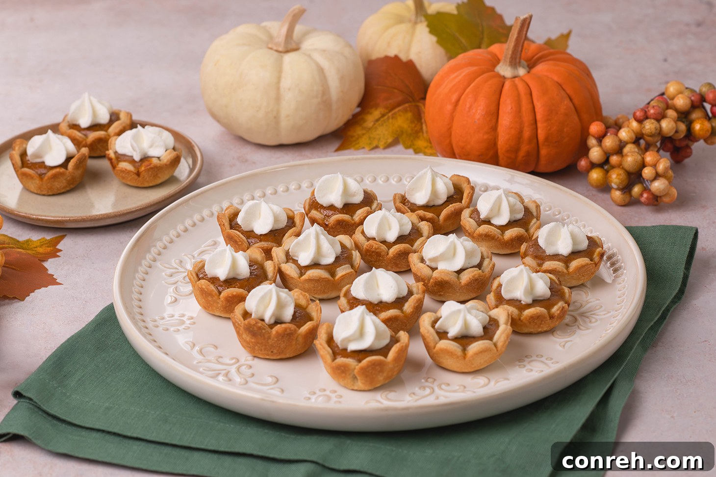 Two hands holding a miniature pumpkin pie with a golden crust and smooth filling.