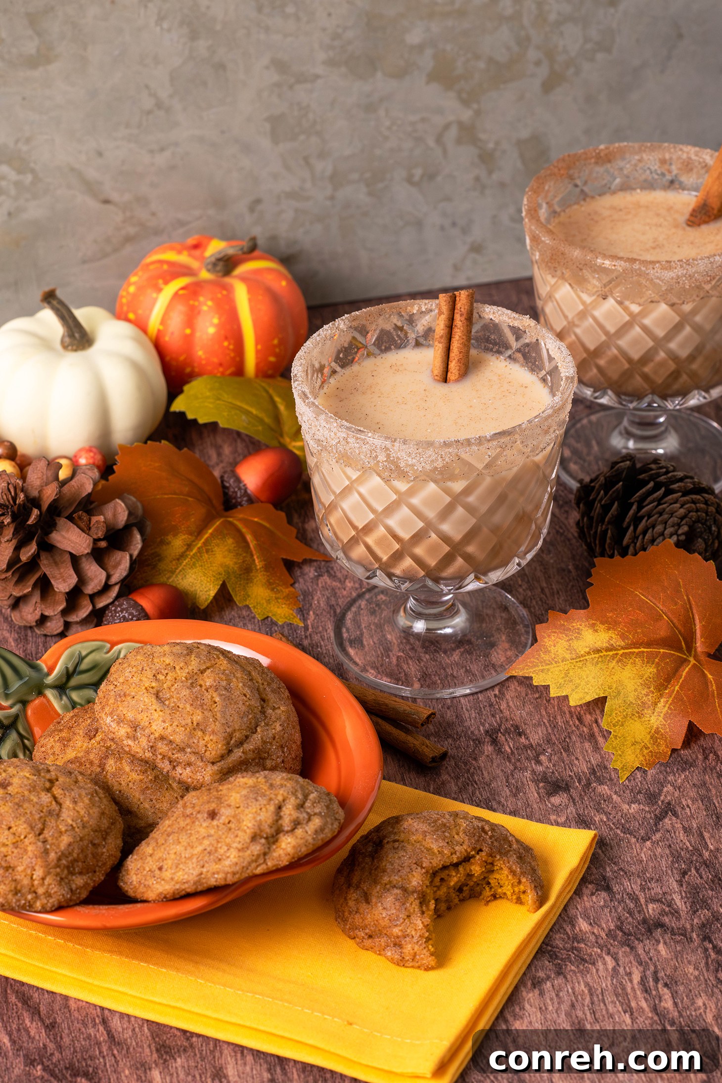 A close-up of a glass of Pumpkin Spiced Rum Horchata, showing the creamy texture and a sprinkle of spices on top.