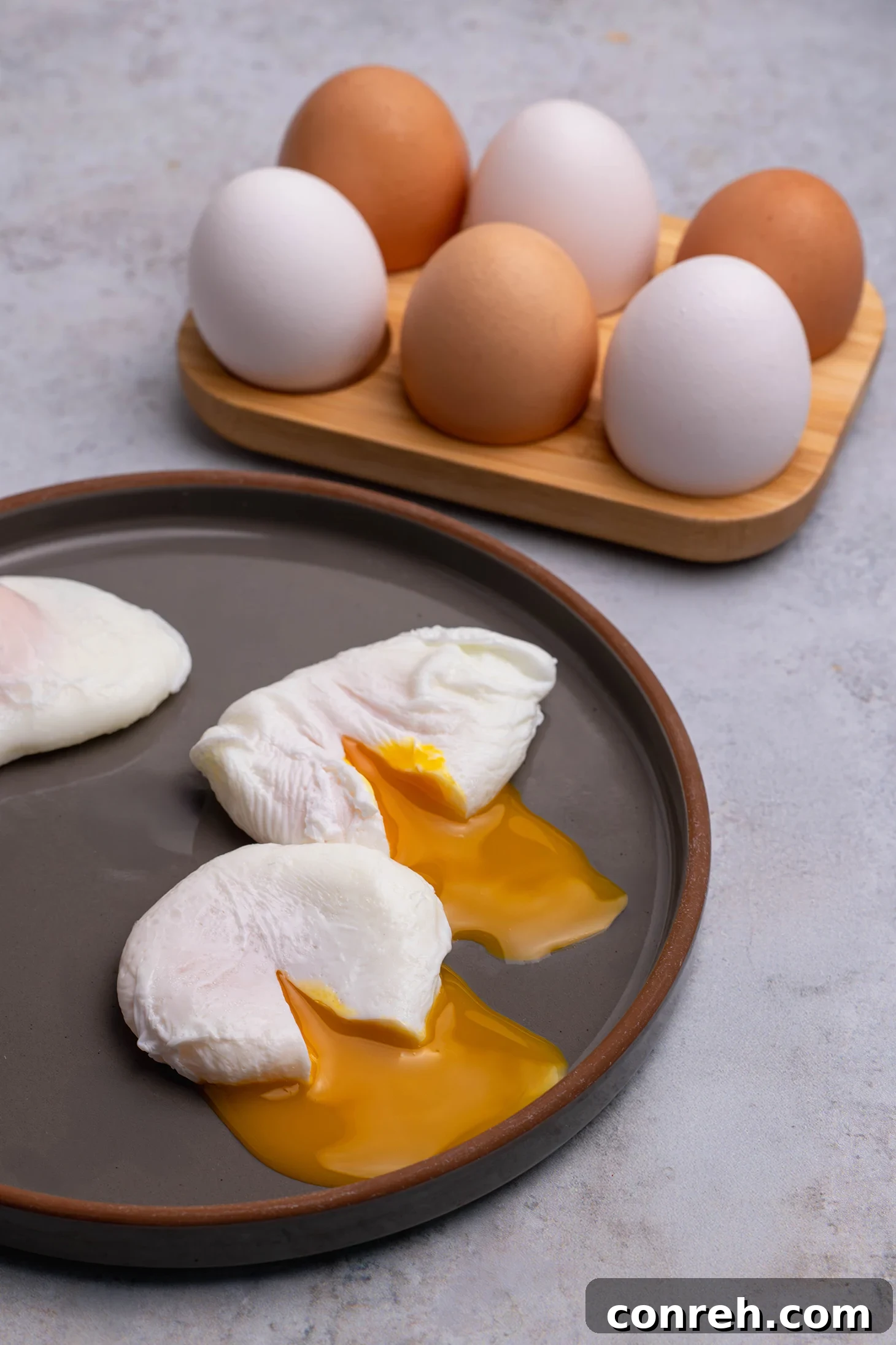 A perfectly poached egg ready to be served, showcasing a bright runny yolk and tender white.